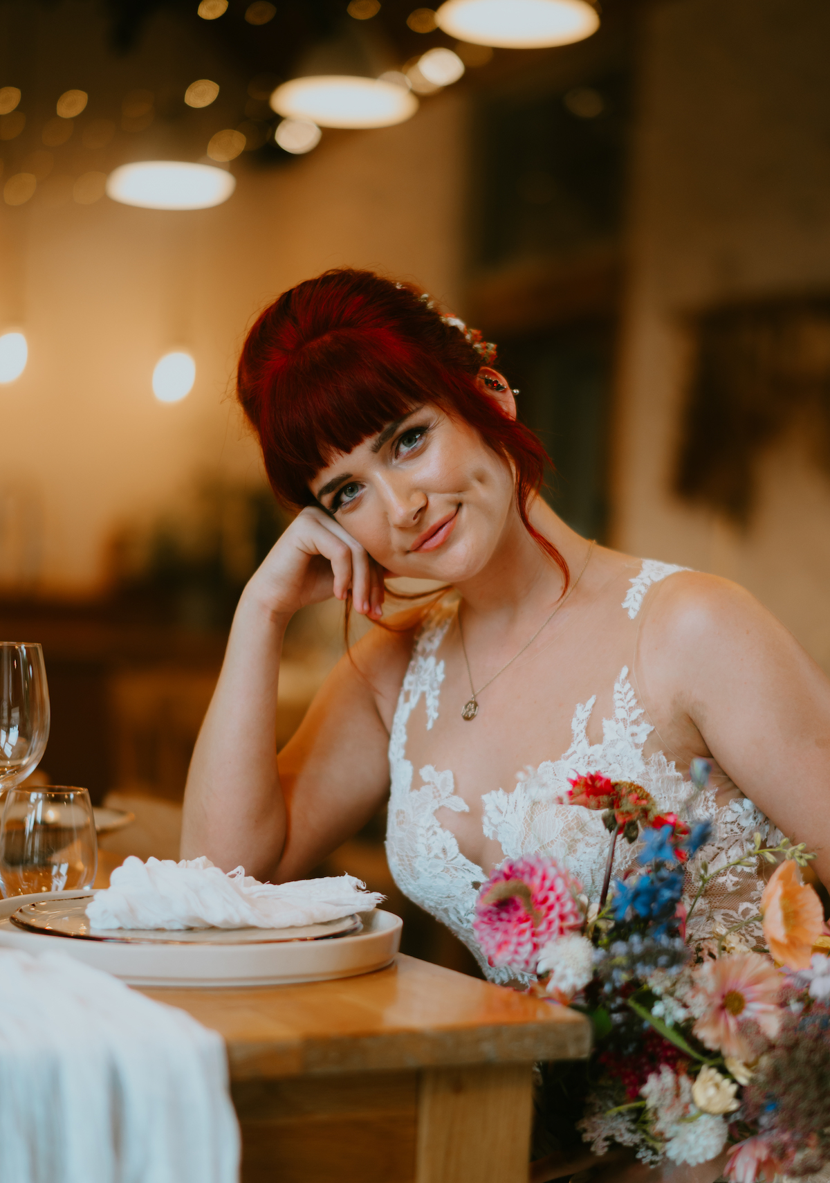 Summer bride at rustic table with colourful flowers